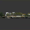 Scenic Campus Landscape With Green Red Playground Wet Surface Buildings And Lush Trees