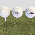 Three Titleist 1 Golf Balls As Sports Equipment Placed On Grass With Tee