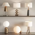 Various Modern Table Lamps Featuring Metal Bases And White Lampshades On Shelf