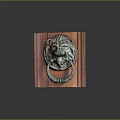 Carved Metal Lion Head Door Knocker On Reddish Brown Wooden Board