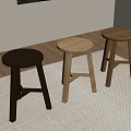Three Different Colored Stools Black Light And Dark Wooden On Carpeted Floor In Room