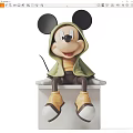 Mickey Mouse Sculpture Wearing Green Hoodie Yellow Top Brown Pants On White Platform