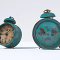 Vintage Teal Alarm Clocks With Worn Surfaces And Classic Bell Tops