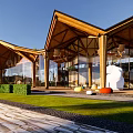 Modern Visitor Center With Wooden Gabled Roof And Glass Curtain Walls In Natural Surroundings