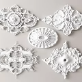 Ornate White Carvings with Intricate Designs and Various Shapes as Decorative Accents