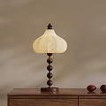 Wooden Table Lamp With Beige Patterned Shade And Ball Pillar On Desk With Decorative Items