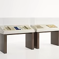 Glass Display Cases With Antique Documents On White Tops And Brown Stands