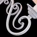Elegant White Metal Wall Sconce with Curved Design and Beige Patterned Lampshade