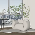 Beige Rounded Single Sofa On White Rug With Black Side Table And City View