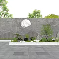 Natural Stone Feature Wall with Circular Design Surrounded by Trees and Paved Plaza under Blue Sky