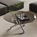 Modern Round Glass Coffee Table with Metal Legs and Plant Vase in Living Room