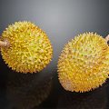 Two Fresh Durian Fruits With Spiky Yellow Exterior On Dark Reflective Surface