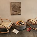 Rattan Lounge Chairs Beige Cushions Round Stone Table Fruits Tray Open Book Abstract Wall Art