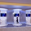 Modern Technology Exhibition With Transparent Display Booths Screens And Person Standing