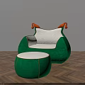 Green Armchair With White Cushion Orange Armrests And Matching Ottoman On Herringbone Wooden Floor