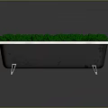 Black Bathtub With White Rim And Metal Legs Filled With Green Grass