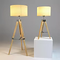 Two Beige Fabric Lampshade Wooden Tripod Floor Lamp Set On White Pedestal