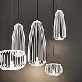 Modern White Wireframe Pendant Lights With Unique Shapes Hanging In Dark Setting