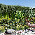 Lush Green Plant Wall Featuring Plants Yellow Flowers Deer Statue And Pebbles In Garden
