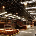 Spacious Warehouse Interior With High Metal Roof Skylights Multi Level Shelves And Smooth Black Floor