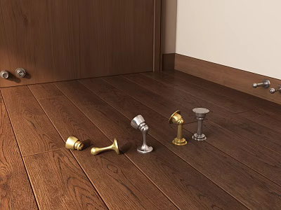 Various Metal Door Stops On Wooden Floor With Gold And Silver Finishes 3d model