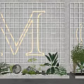 Glass Block Wall with Large Neon Letters M and G Green Plants and White Decorative Sphere