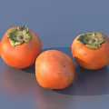 Three Ripe Persimmons With Vibrant Orange Skin And Green Calyxes On Smooth Surface