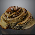 Swirled Cinnamon Roll With Golden Brown Surface And White Sugar Sprinkles