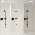 Modern Multi Stall Restroom with White Tiled Walls and Black Showerheads