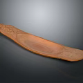 Brown Wooden Long Tray With Intricate Carved Patterns And Textured Surface