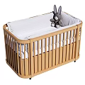 Wooden Baby Crib With Light Wood Slatted Railings White Mattress And Gray Rabbit Toy