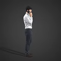 A Man Standing And Talking On Mobile Phone In White Shirt And Dark Pants