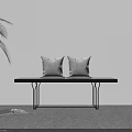 Minimalist Indoor Corner With White Wall Green Plant Black Bench Gray Cushions And Open Book