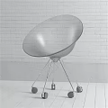 Transparent Leisure Chair with Metal Base and Wheels against White Brick Wall