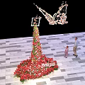 Butterfly Shaped Floral Installation With Tall Flower Arrangement And People Interacting On Checkerboard Floor