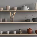 Minimalist Tea Ware On Gray Shelf With Teapots Cups Bowls Wooden Spoon Holder And Pomegranates
