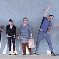 Group of People With Various Poses Standing Against Concrete Wall Holding Documents And Shopping Bag