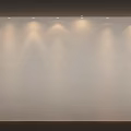 White Wall With Row Of Overhead Lights Creating Light Spots In Modern Display Space