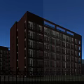 Red Brick School Building With Curved Design And Large Glass Windows Featuring Students On Campus