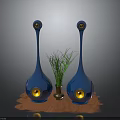 Modern Blue Vase Shaped Speakers With Green Plant And Brown Mat