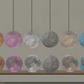 Colorful Moon Shaped Floor Lamps With Multiple Hues On Wooden Shelf Gray Background