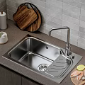 Stainless Steel Kitchen Sink on Dark Countertop with Modern Faucet Wooden Cutting Boards and Fresh Lemon Slices