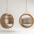 Set of Two Rattan Round Hanging Chairs With Soft Cushions In Light Background