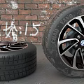 Stacked Car Tires And Tire With Volkswagen Wheel Rim On Brick Wall Background