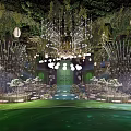 Luxurious Banquet Hall Setup With Hanging Greenery Chandeliers Round Tables And Soft Lighting