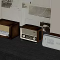 Vintage Wooden Radios Arranged In Three Sizes On Black Table With Retro Wall Decor