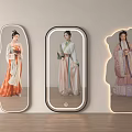 Unique Shaped Illuminated Mirrors Reflecting Women In Traditional Costumes