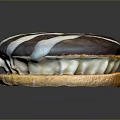 Chocolate Frosted Pastry With White Striped Decoration Light Brown Base And Cream Filling