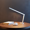 Modern Flexible Arm Desk Lamp on Wooden Round Table with Books and Coffee Cup