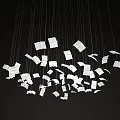 Creative Chandelier With White Book Page Shaped Elements Hanging On Thin Wires Against Black Background